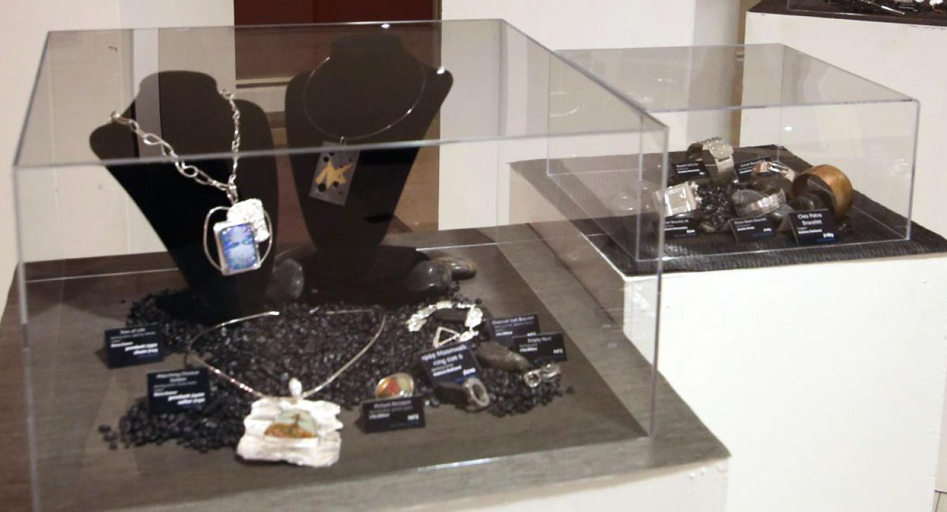 Various student works on fish rocks in display cases