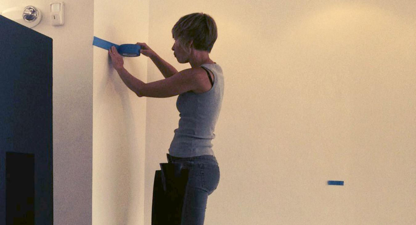 Helena putting up painting tape