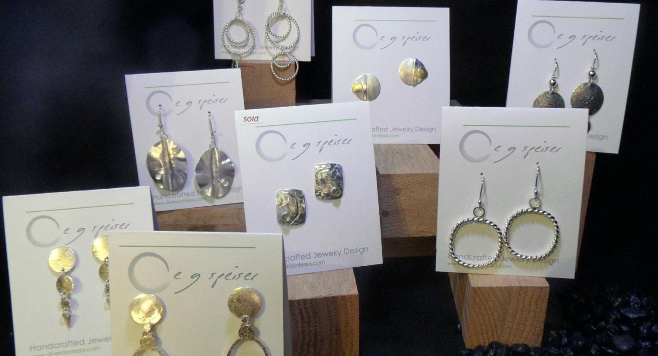 Silver and gold earrings on stock, by Elaine 