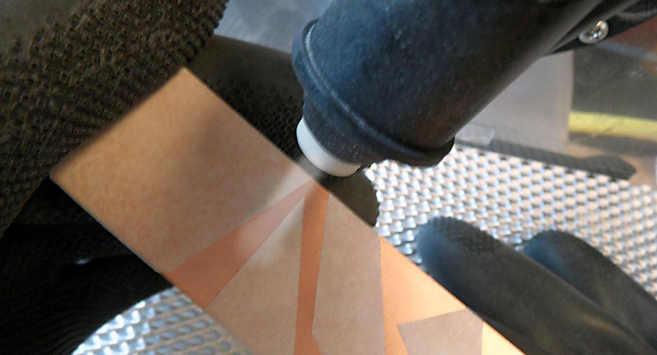 closeup of the blasting nozzle on a copper sample 