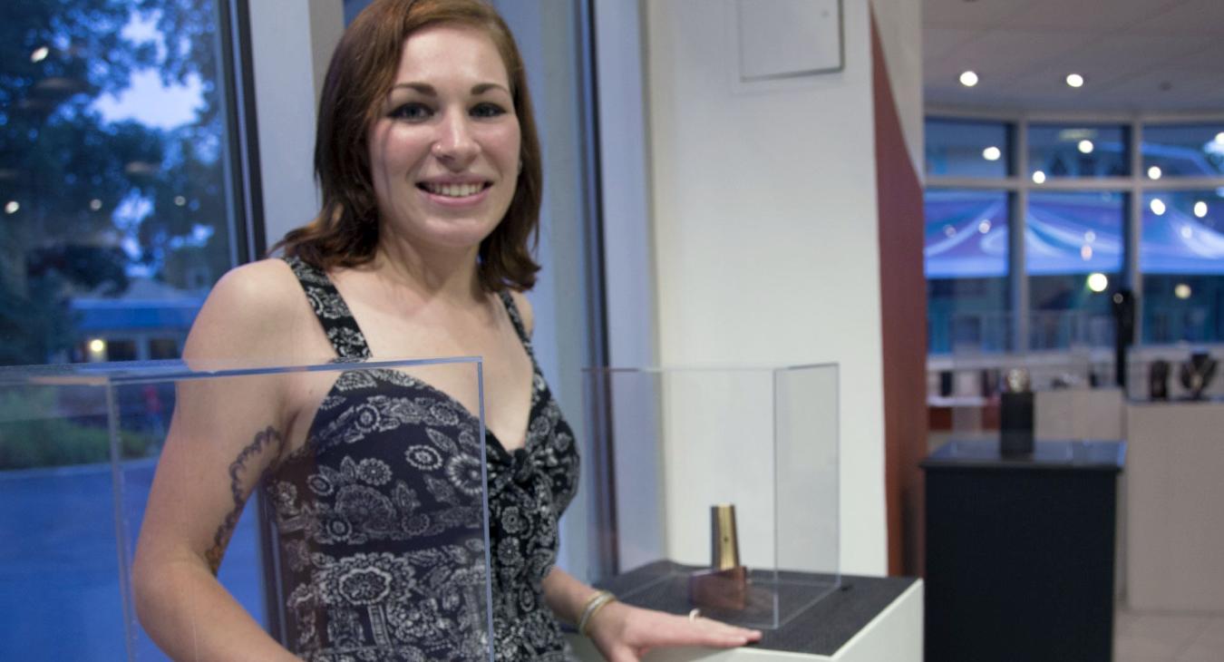 Heather standing by display cases of her work