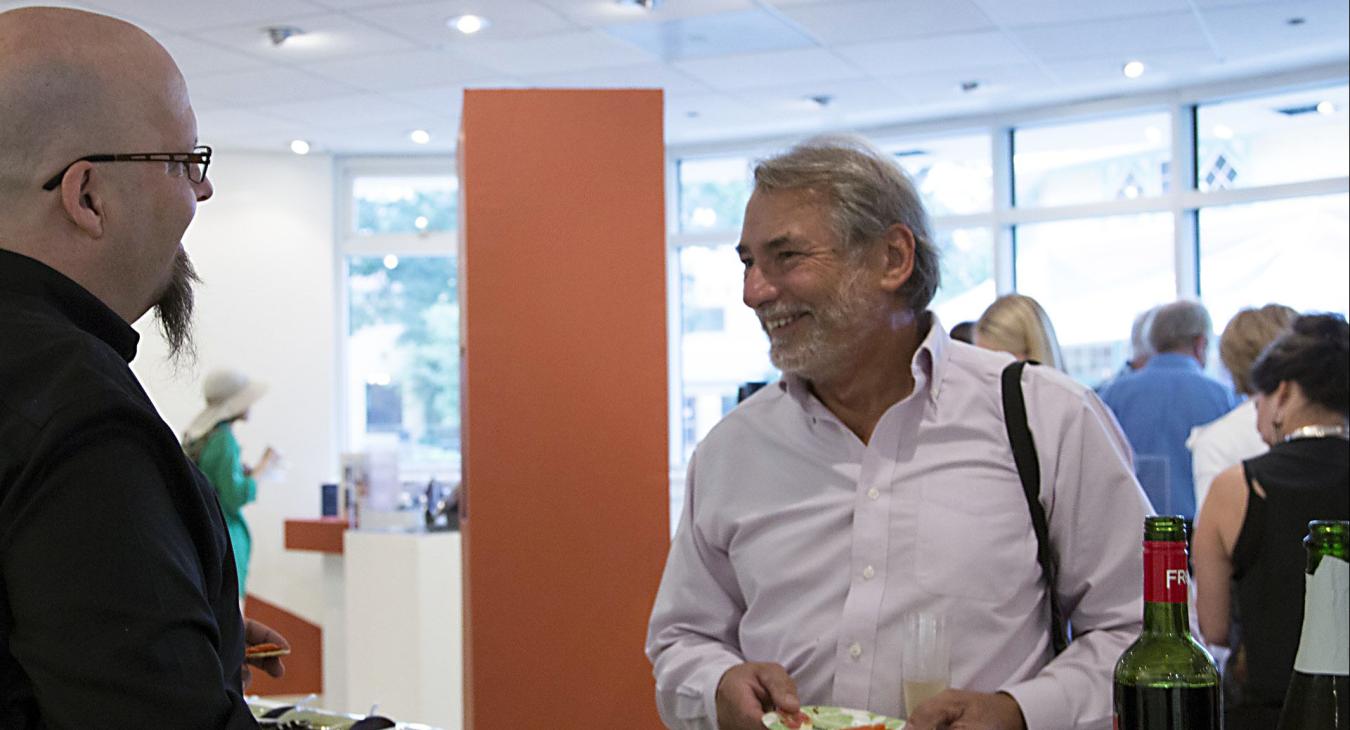 Bryan talking to patrons by the refreshments