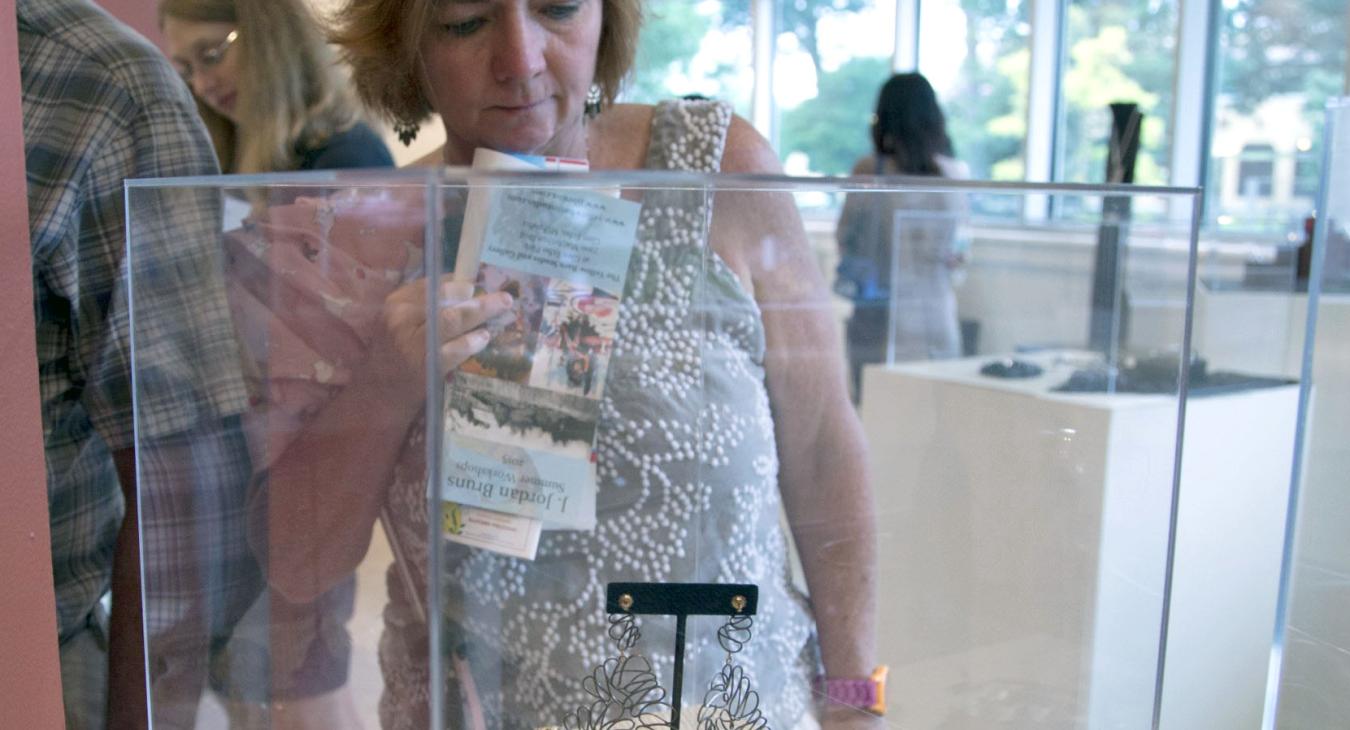 a guest viewing work in a display case