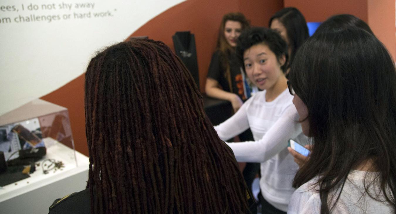 Kai talking with guests by her displayed work