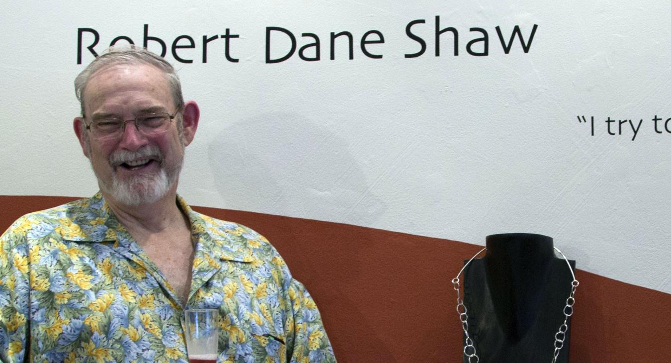Robert standing by his name display and work