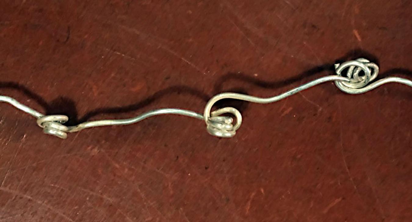 wire chain linked by swirls