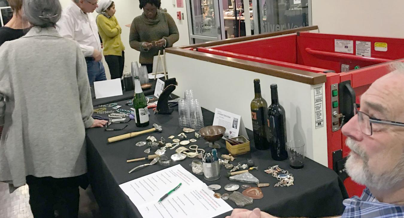 Robert sitting at his table displaying his work and techniques
