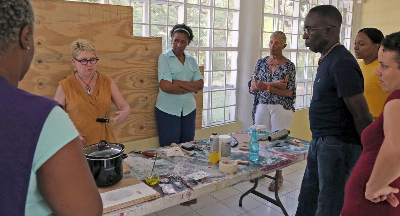 Blair demonstrating to students standing around table
