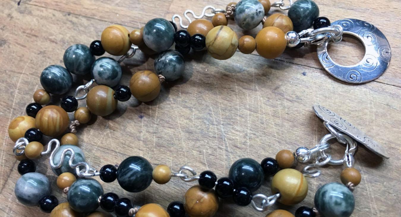 brown and green beaded bracelet withs silver wire and clasp