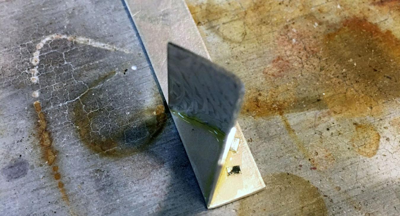 soldering silver pieces together for frame