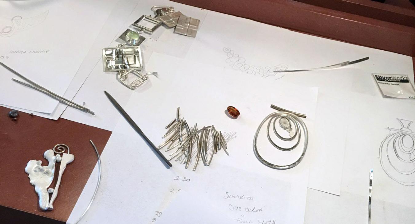 several projects in process laid out on paper with sketches