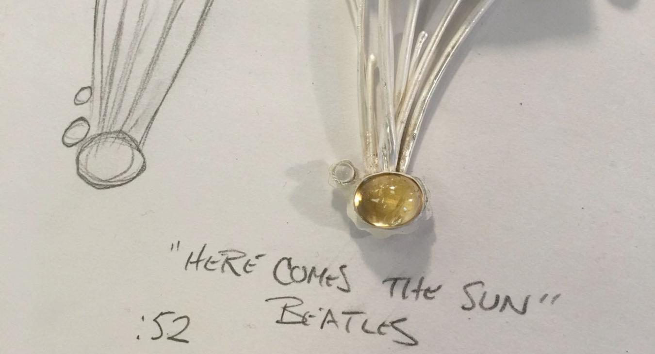 sketch and unfinished silver pendant with pyrite and lower hanging citrine and moonstone