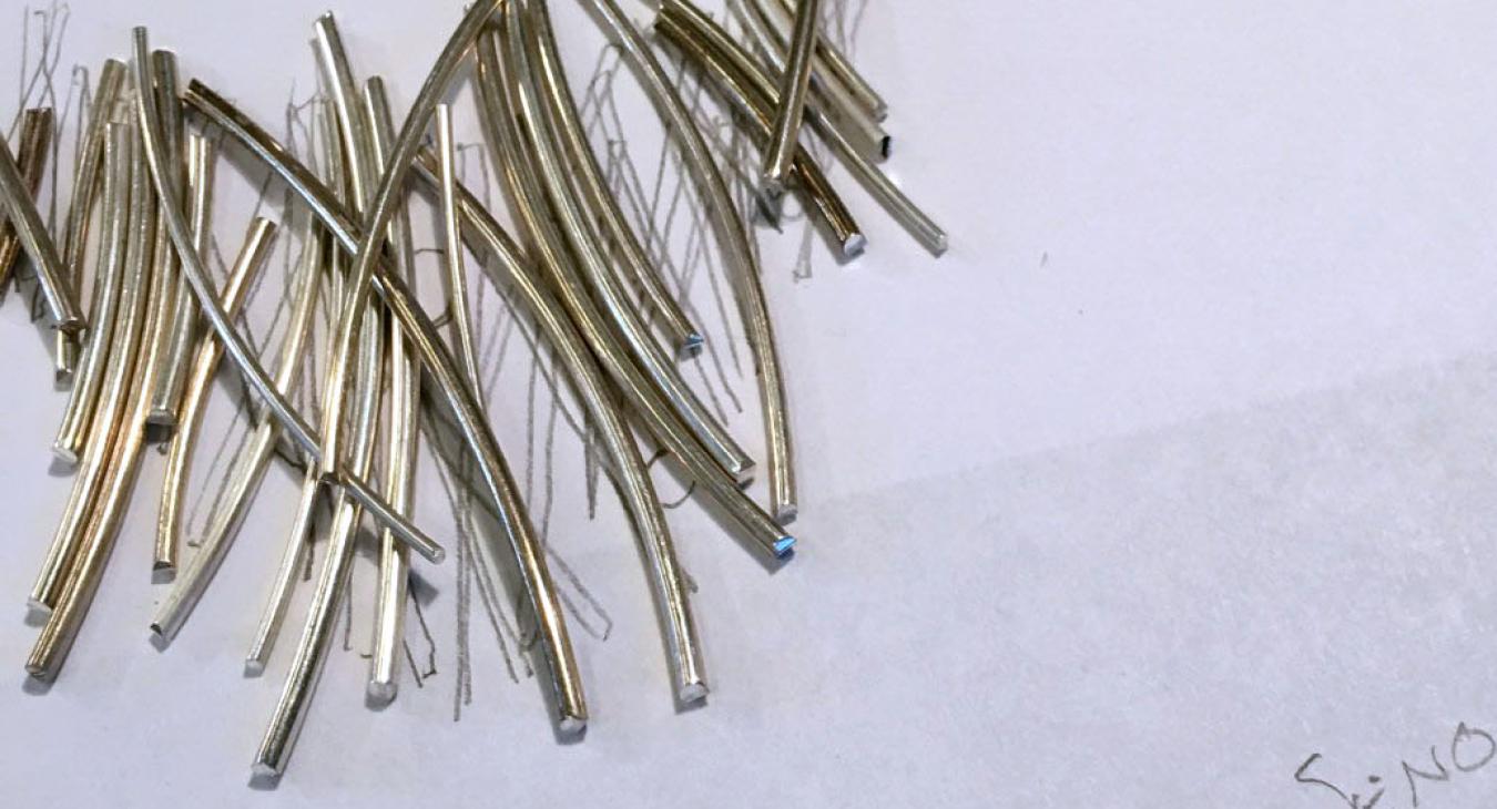 cluster of silver wire pieces on concept sketch paper