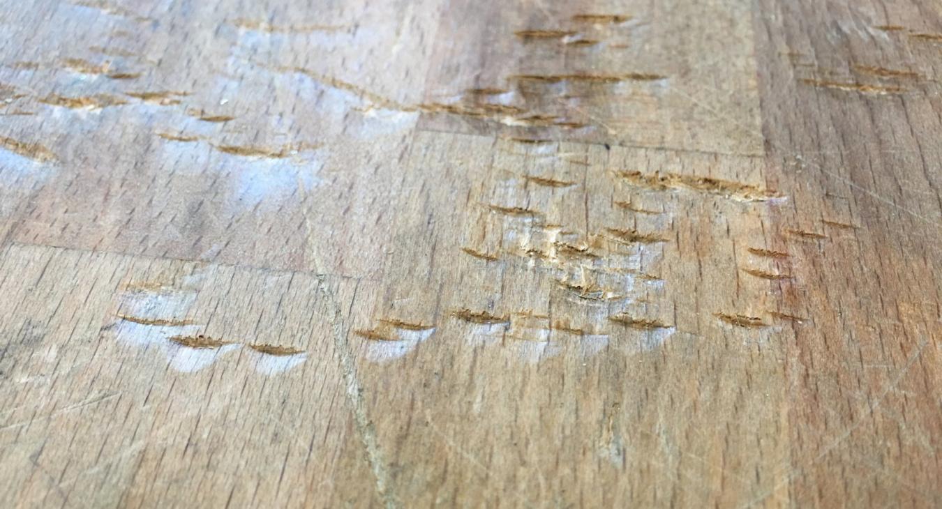 wooden surface with deep gouges
