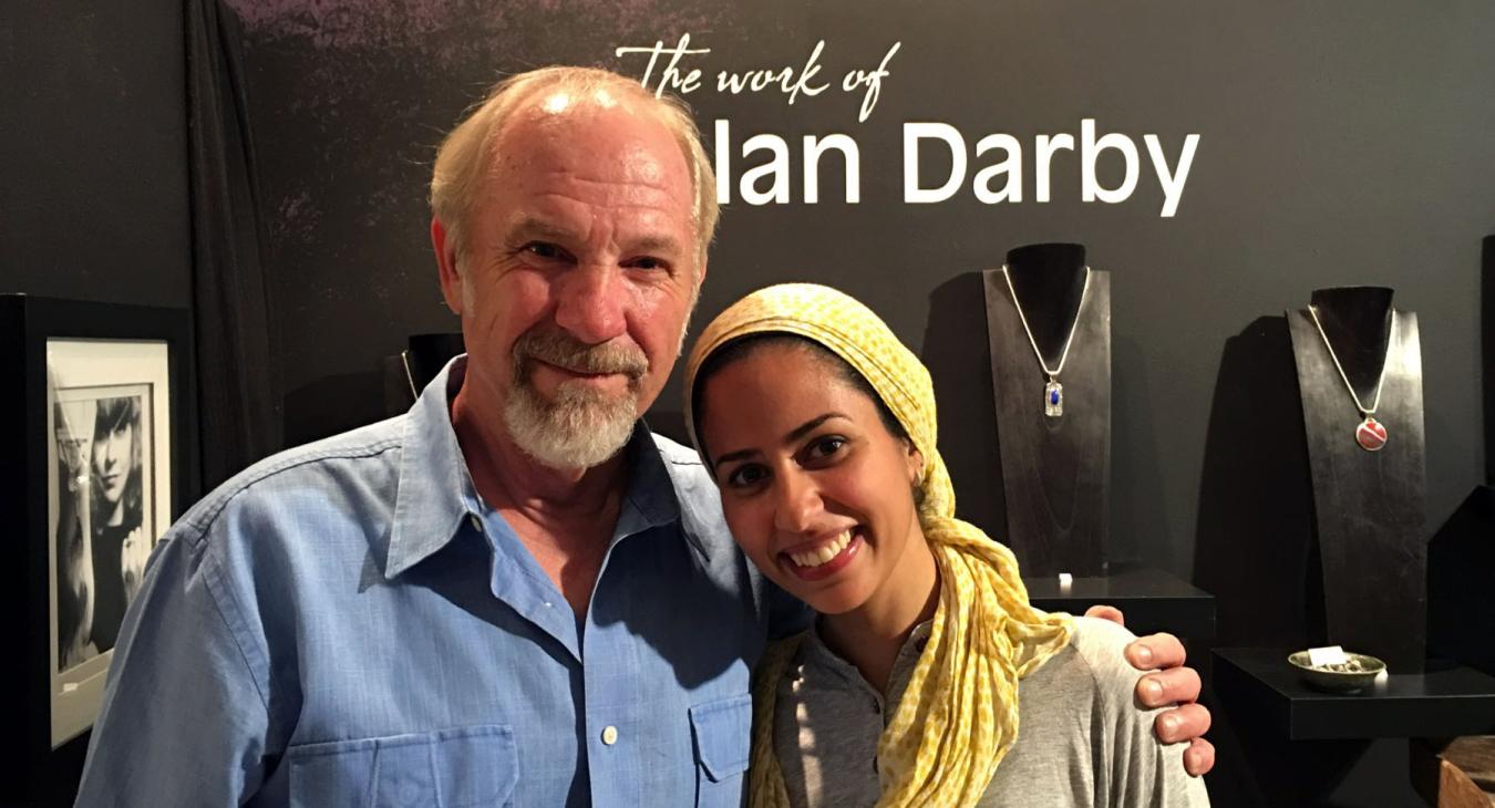 alan and mawadda posing in front of his name and work