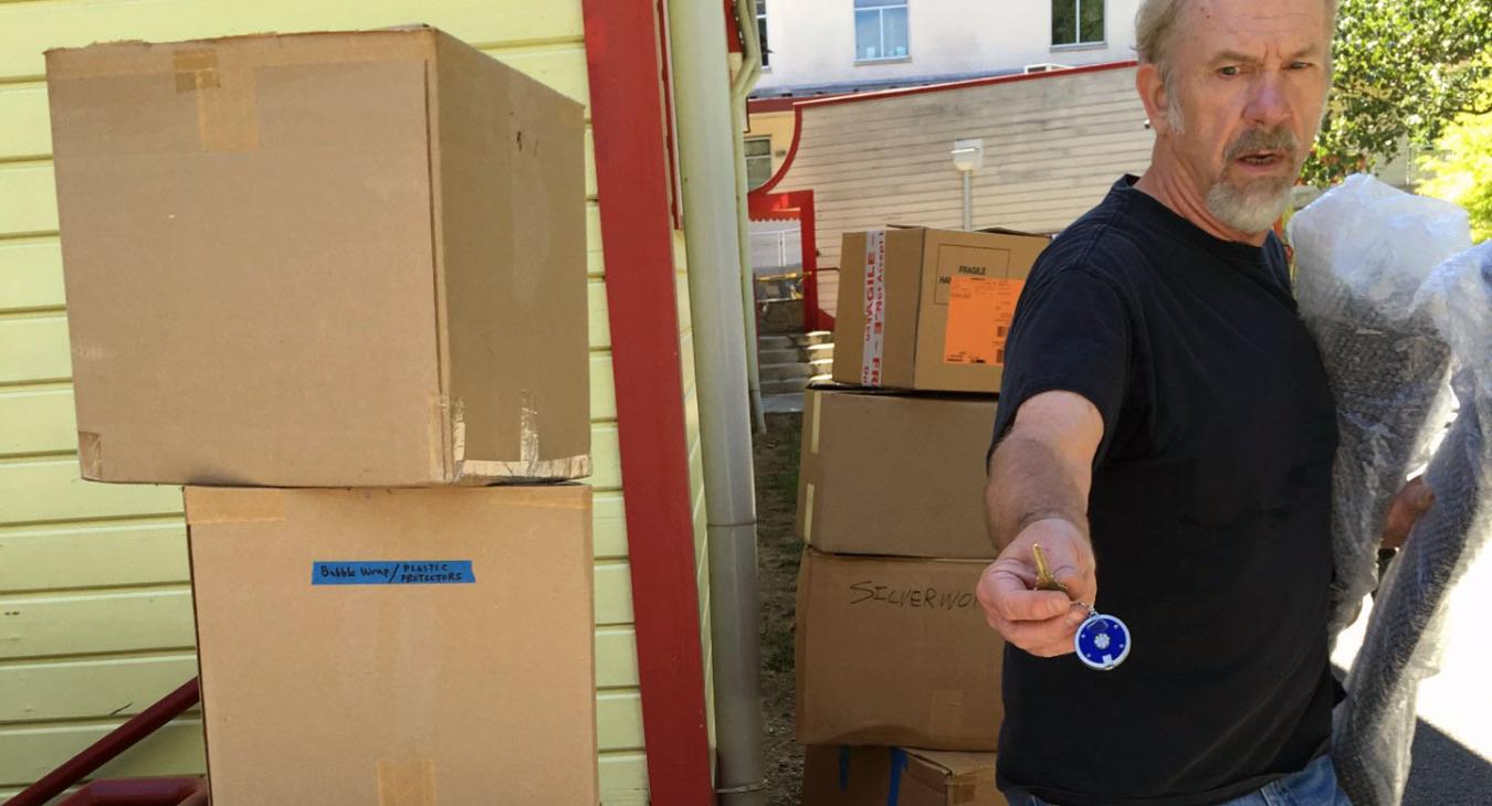 alan next to boxes and crates for show