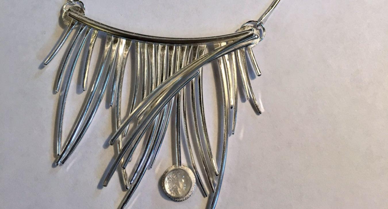 silver wire piece on dog bone chain