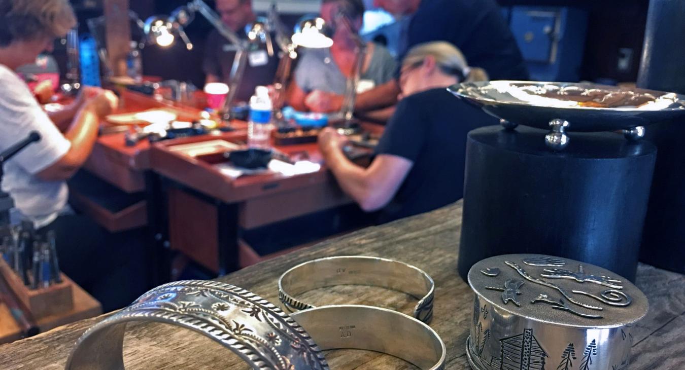 Foreground: stamped cuffs and boxes. Background: Alan Darby teaching the workshop.