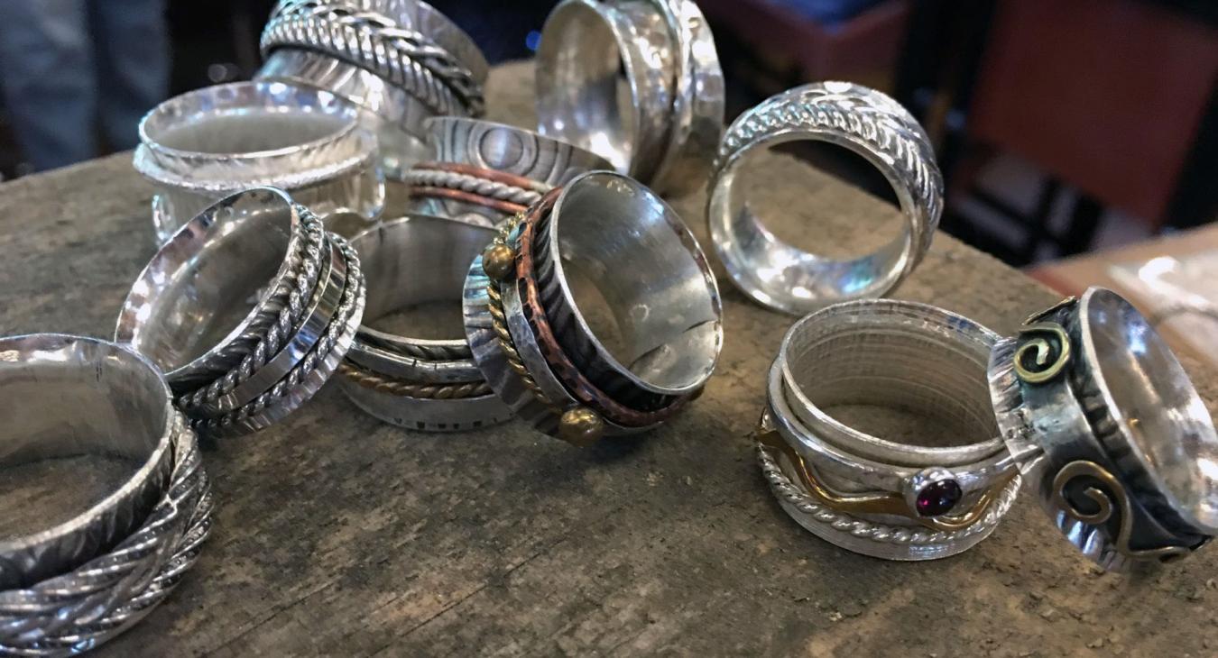 students' silver spinner rings piled up
