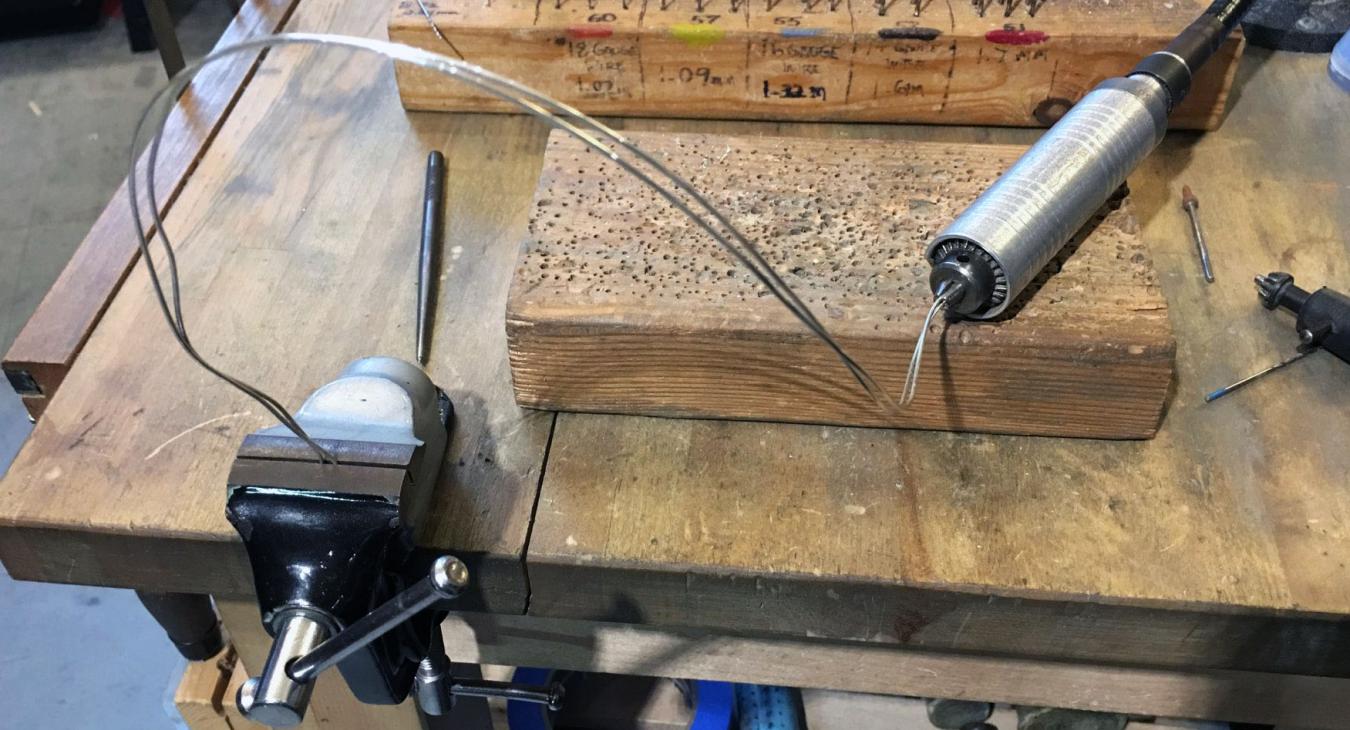 two lengths of wire with one end in flex shaft drill and the other in vice