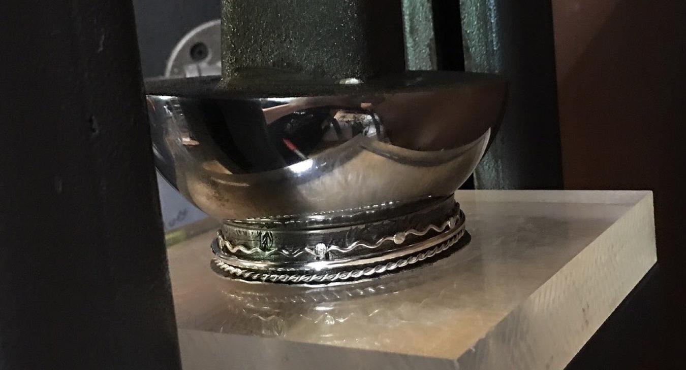 bangle being squished by mushroom stake