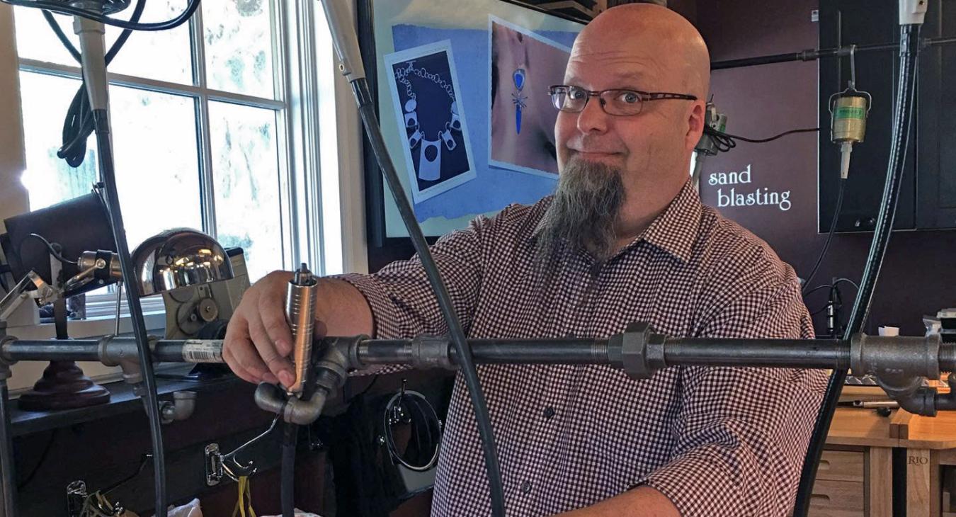 Bryan installing black steampunk piping to hold flexishaft drills