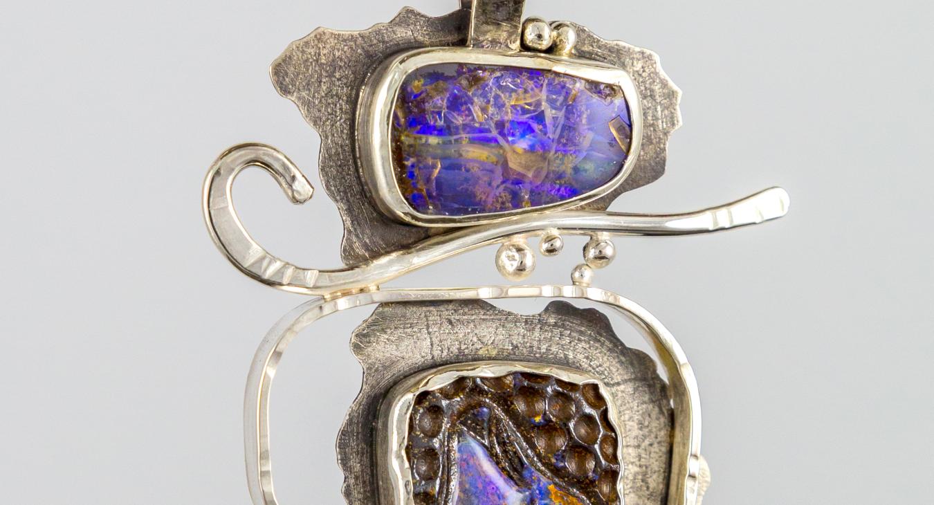 Silver textured pendant with multi-colored purple stones