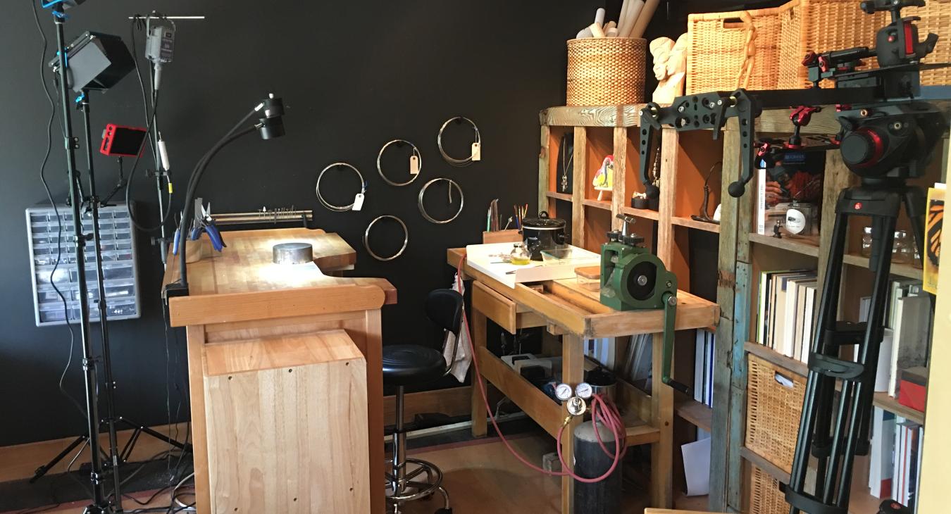 Blair's home studio with bench and shelves and camera setup