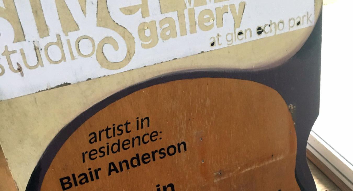studio's sandwich board being stripped and repainted