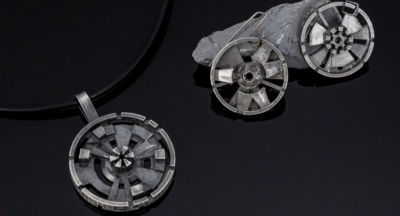 sterling silver "data ports" displayed on rock and as pendant