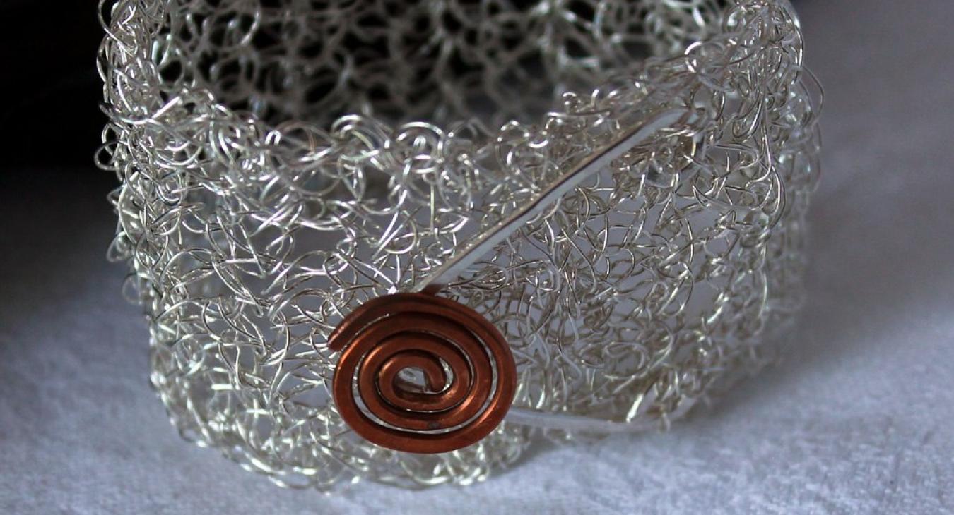 crocheted silver wire cuff with copper spiral button