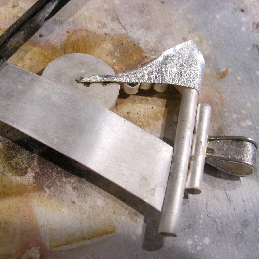 Preparing to solder the glass bezel to the structure