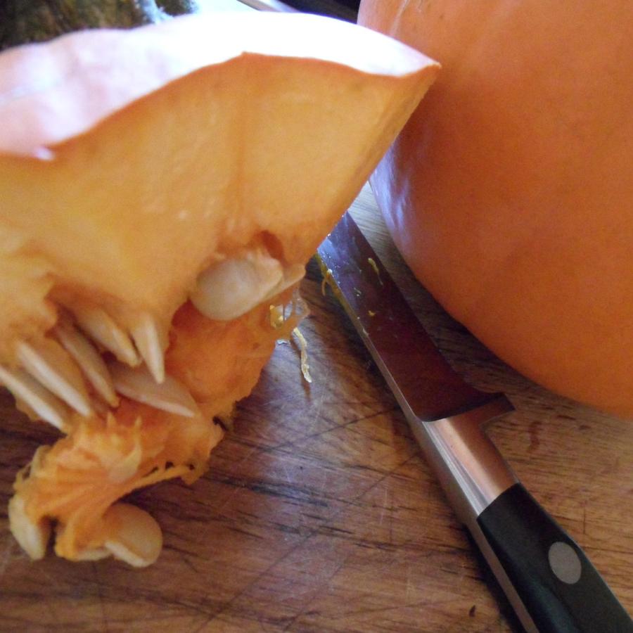 Knife next to pumpkins starting to be carved