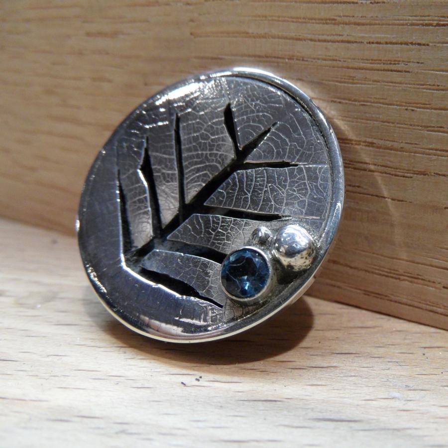 Layered broach with leaf pattern and blue gem stone 