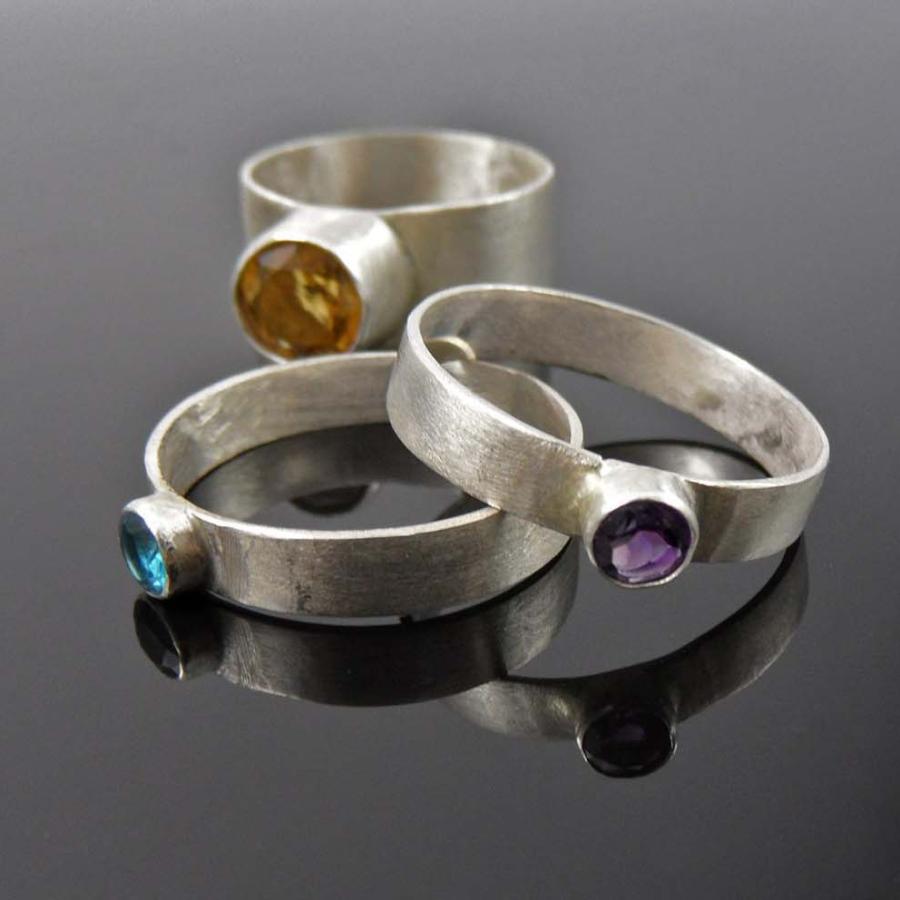Facetted ring set by Roxana Fugleberg with amethyst, quartz, and topaz.