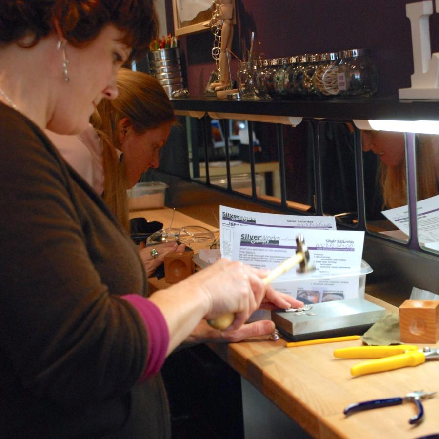 Student hammering piece on anvil