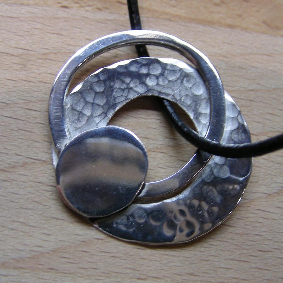 Multi-layered circular silver pendant