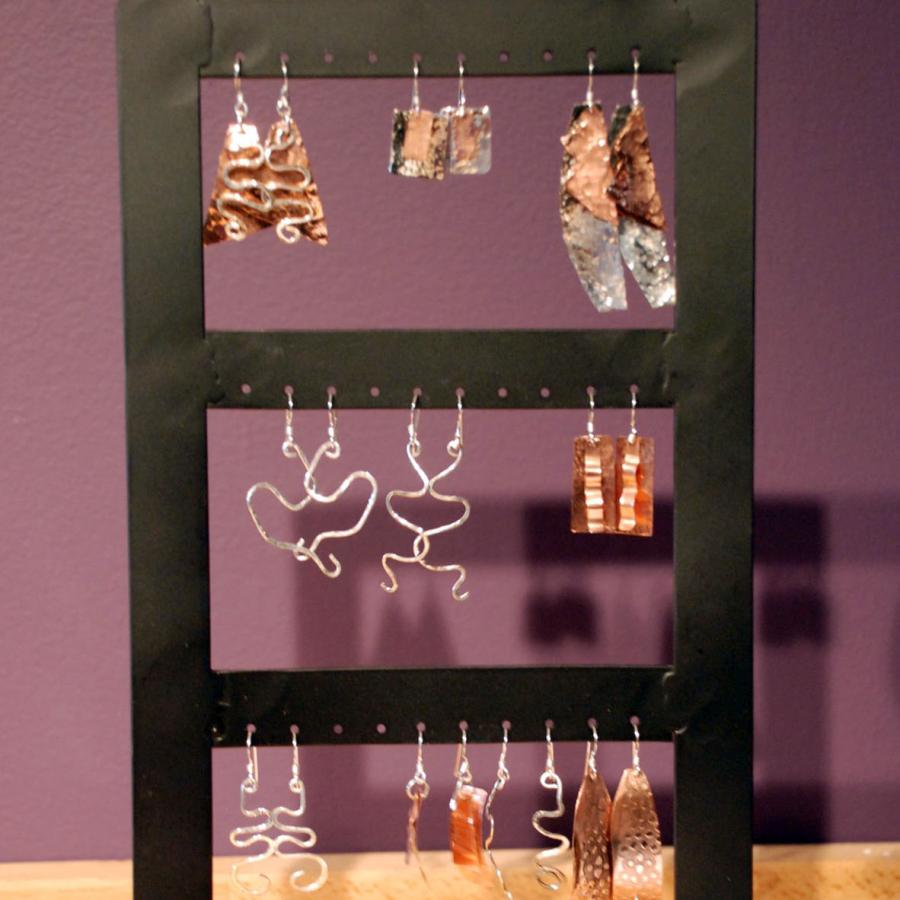 A display of silver and copper earrings