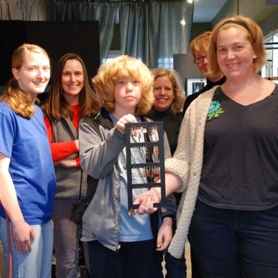 Students showing the earrings they made.