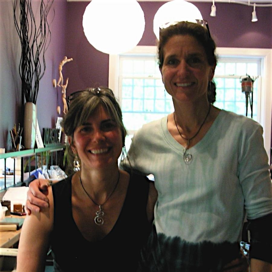 Samantha and Sarena wearing their swirl wire pendants