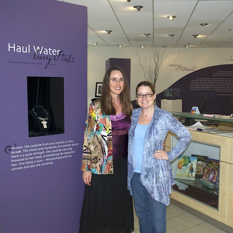 Blair and Megan in front of a tower display