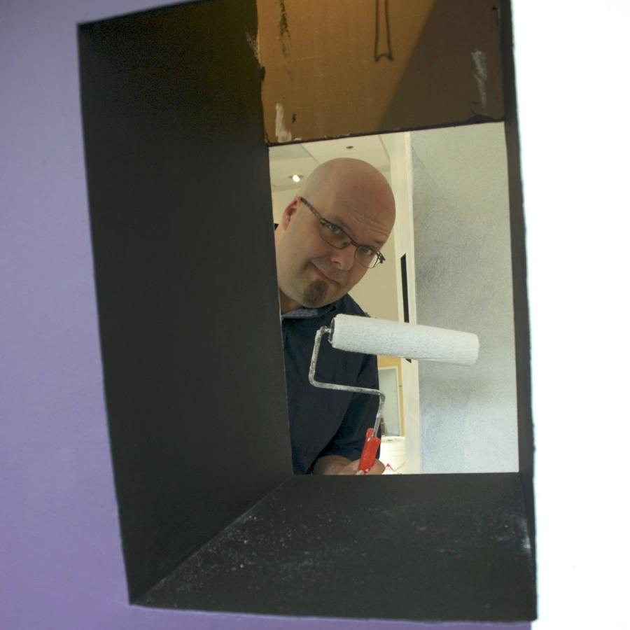 Bryan peeking through one of the towers with a paint roller