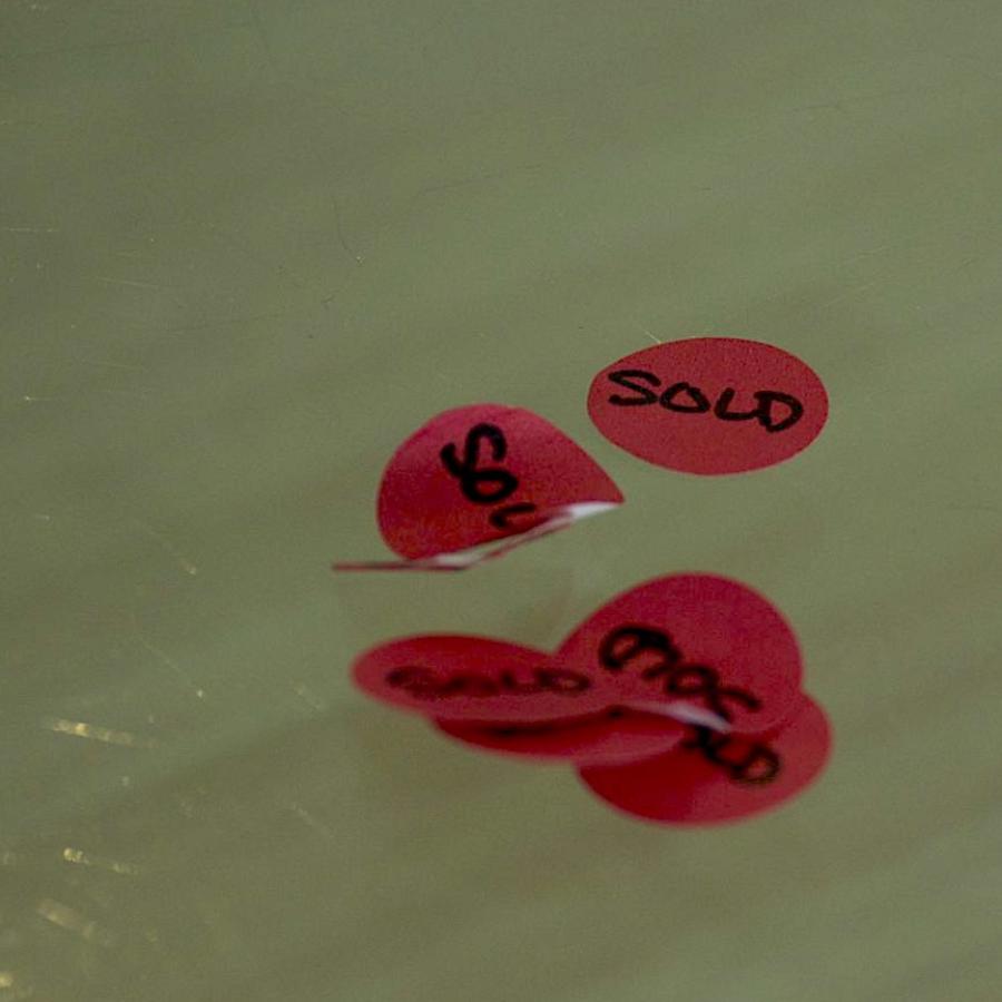 Red stickers that say "sold"