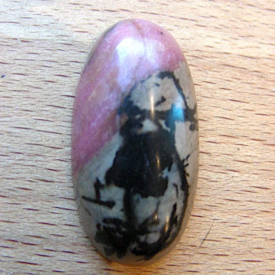 Pink brown and black rhodonite oval cabochon
