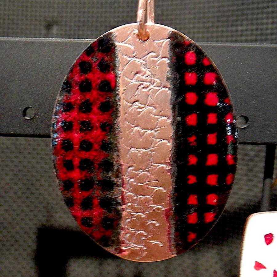 Enameled copper pendant with red and black checkered pattern