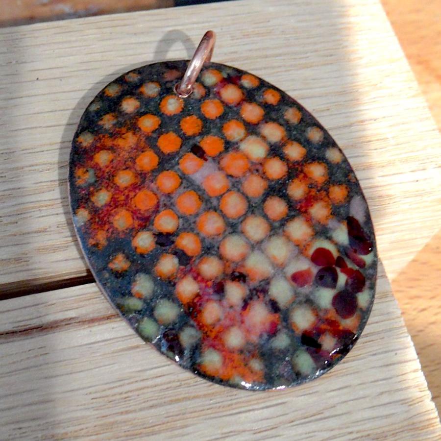 Enameled black and orange checkered pattern pendant