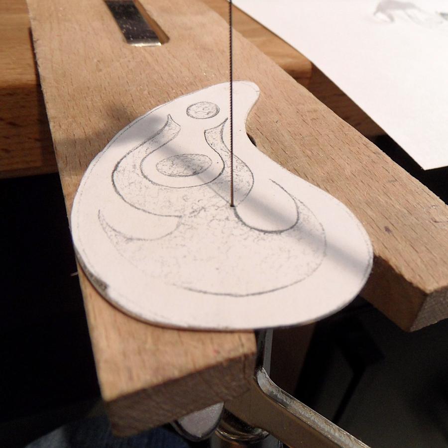 Sawing out the design in sterling silver