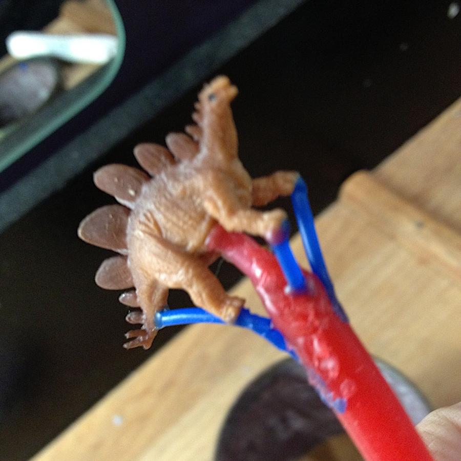 A little plastic dinosaur on a sprue for casting.