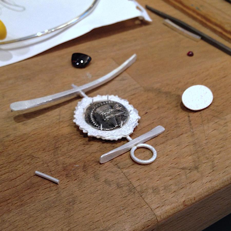 Testing the fit of the coin for the pendant