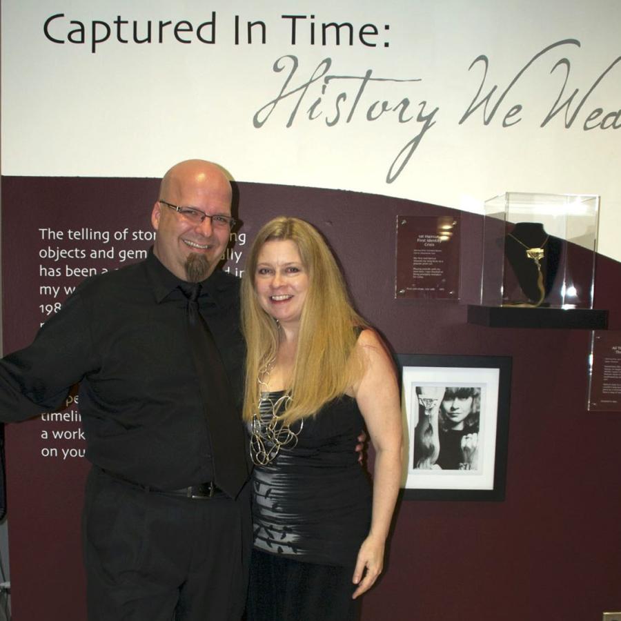 Blair and husband Bryan in front of the title wall